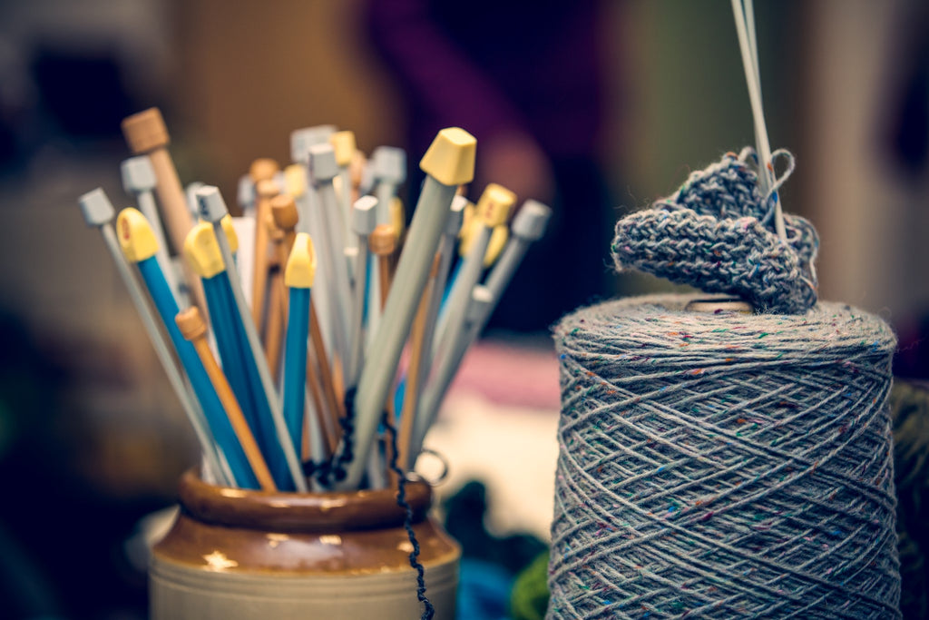 Aran knitting needles in two sizes and a tapestry needle